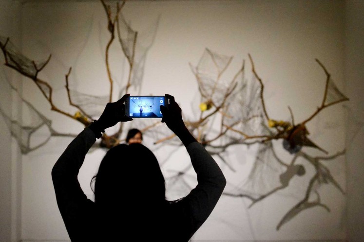 A display at ARTJOG 2016 is used as a backdrop by young visitors taking pictures.
