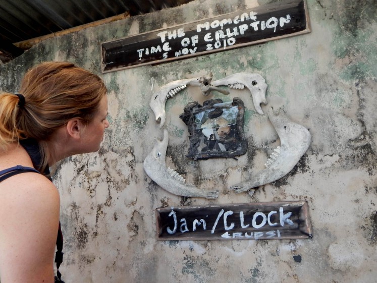 A foreign tourist looks at a clock that melted in the eruption of Mount Merapi, on display at the Mini Museum complex in Petung village, Cangkringan, 7 kilometers away from the peak of the mountain. 
