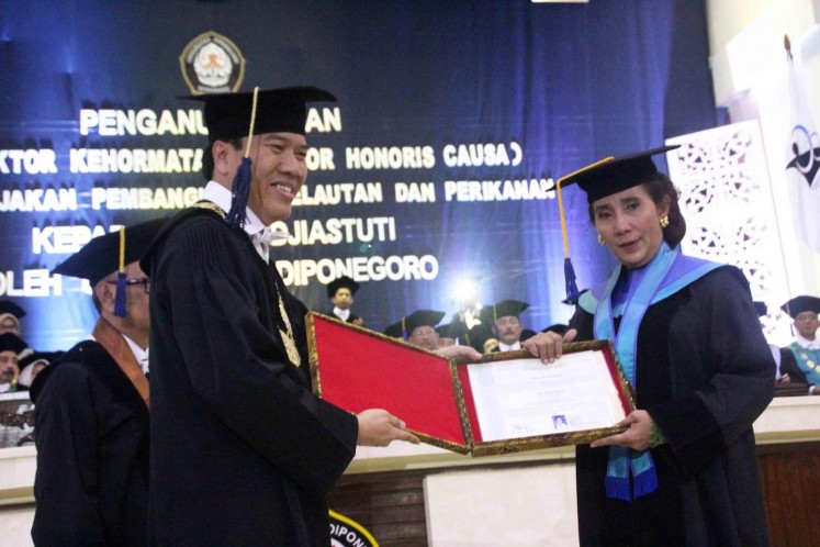 Doctor — Maritime Affairs and Fisheries Minister Susi Pudjiastuti (right) receives an honorary doctorate from Diponegoro University rector Yos Johan Utama at the university’s campus in Semarang on Saturday.
