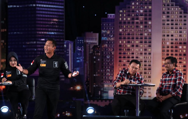 Then gubernatorial candidate Agus Yudhoyono (second left) answers a question during an election debate in Jakarta on Jan.13, 2017. 