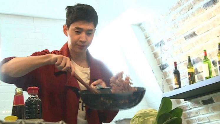 Henry of Super Junior M is seen cooking during an apprentice under a renowned Korean chef. 