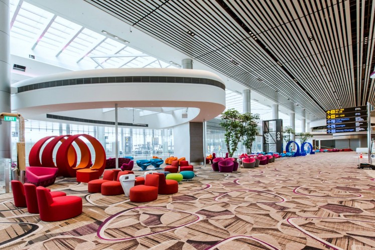 Colorful and cushy chairs in the departure transit area at Changi's Terminal 4.