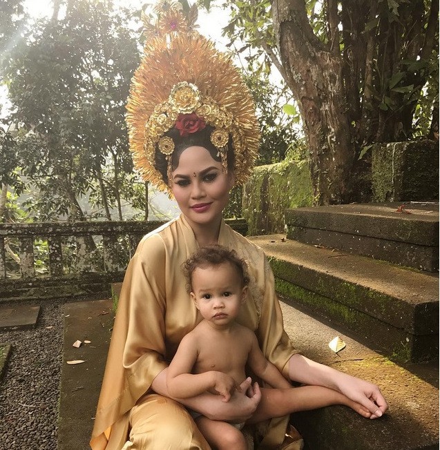 Teigen also shared her photo while wearing this all-gold outfit and holding daughter Luna in her lap. 