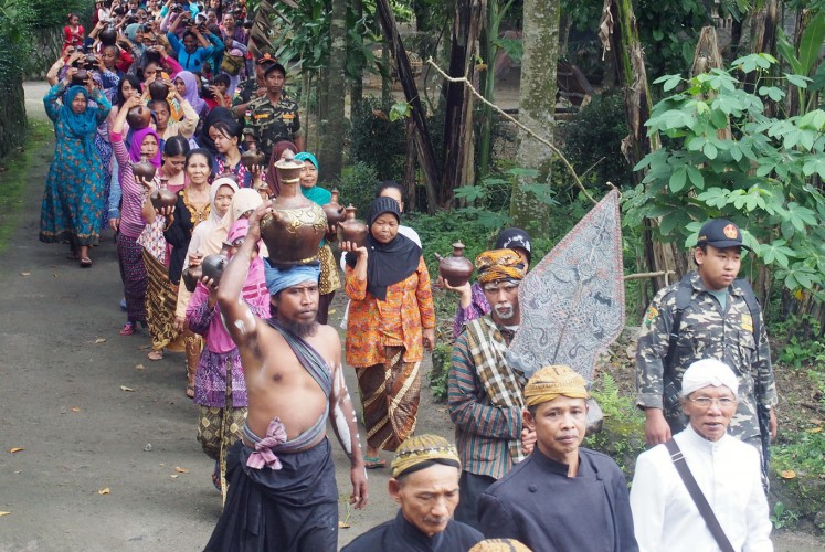 Giving thanks: Bunder residents parade jugs containing rainwater, a tradition handed down through generations as a way of appreciating the abundant rainwater bestowed on them.