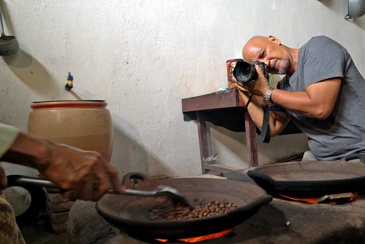 Documenting: Rio Helmi takes a photo of local coffee maker.