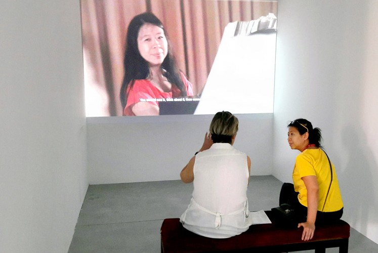 Interaction: A visitor discusses with artist Tintin Wulia her video 1001 Martian Homes at the Indonesian pavilion during the Venice Art Biennale 2017.