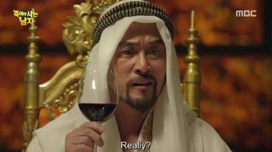A scene in which Saeed Fahd Ali drinks wine.