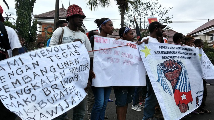 United: Around 30 students of the Papua Student Alliance Bali hold a rally in Denpasar on Aug. 2. 