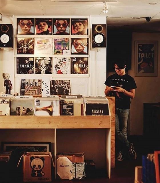 Thumbing through: Music fans snap a photo of vinyl records displayed for customers at Bandung's newest record store KeepKeep Music.