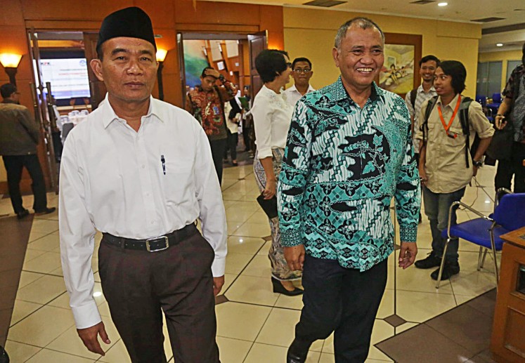 Education and Culture Minister Muhadjir Effendy (left) walks with Corruption Eradication Commission (KPK) chairman Agus Rahardjo after the signing of a Memorandum of Understanding (MoU) at the Education and Culture Ministry in Jakarta, on Thursday, Aug. 3, 2017. 