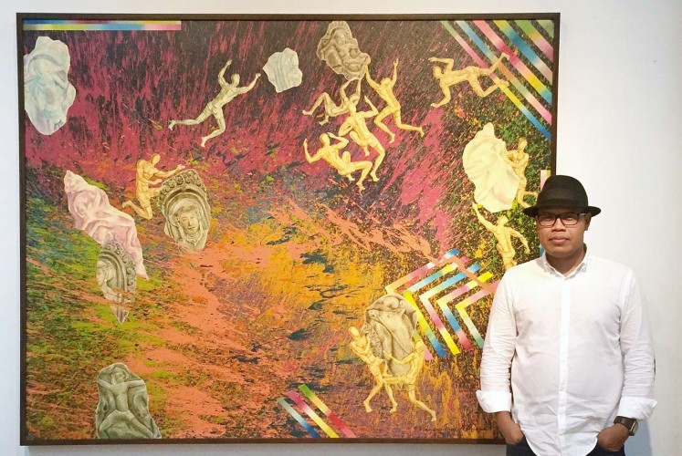 The artist: Kun Adnyana poses with his painting Ancient Artifact Discovery at the Bentara Budaya cultural center in Jakarta. The exhibition runs until Aug. 8.