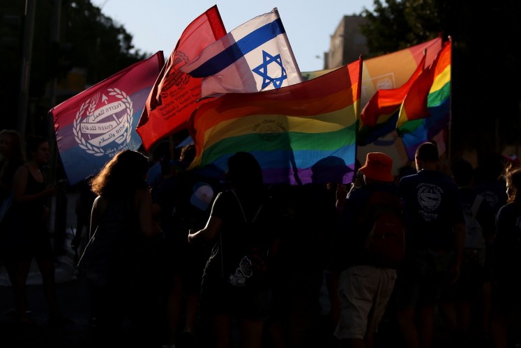 Thousands of revelers attended Jerusalem's Gay Pride parade under police protection on Thursday, bringing the rainbow flag to the traditionally conservative city.