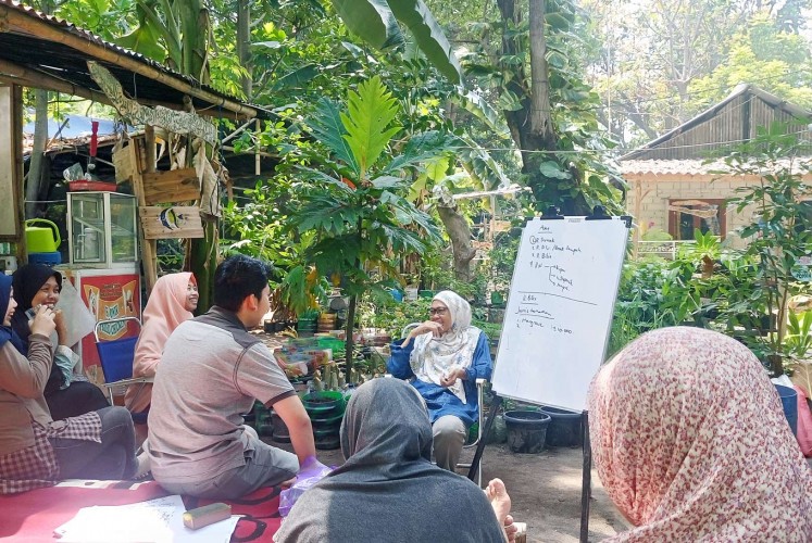 Empowerment: Mahariah leads a meeting with local residents in Pramuka Island, Thousand Islands regency, as part of her Rumah Hijau (Green House) movement, which aims to instill environmental habits at the household level.