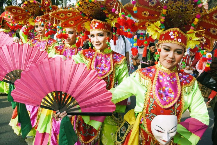 Contrasting colors: Participants from Depok, West Java, perform the Godek Ayu dance in brightly colored traditional costumes during the 12th Cultural Parade from Jl. Semeru to Gajayana Stadium in Malang, East Java.