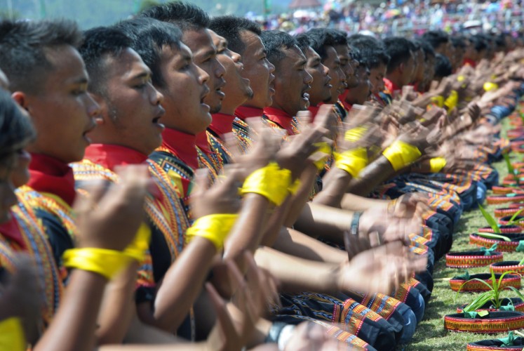 Participants take part in a mass traditional Saman dance performance in the Gayo Lues highland district in Aceh on Indonesia's Sumatra island on August 13, 2017. More than 10,000 people turned out in Indonesia's Aceh on August 13 to stage a record-breaking song and dance performance stressing the need to conserve a threatened national park in the westernmost province.