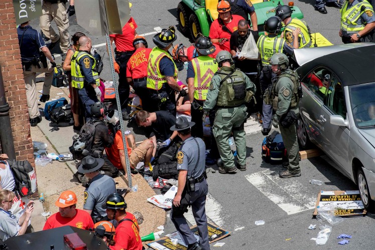 People receive first-aid after a car accident ran into a crowd of protesters in Charlottesville.