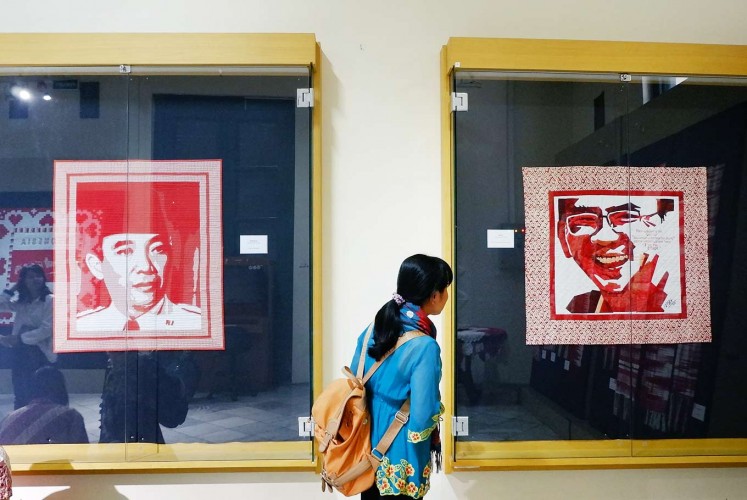 Up close: A visitor looks at quilts depicting Indonesia’s first president Sukarno (left) and former Jakarta governor Basuki Tjahaja Purnama.