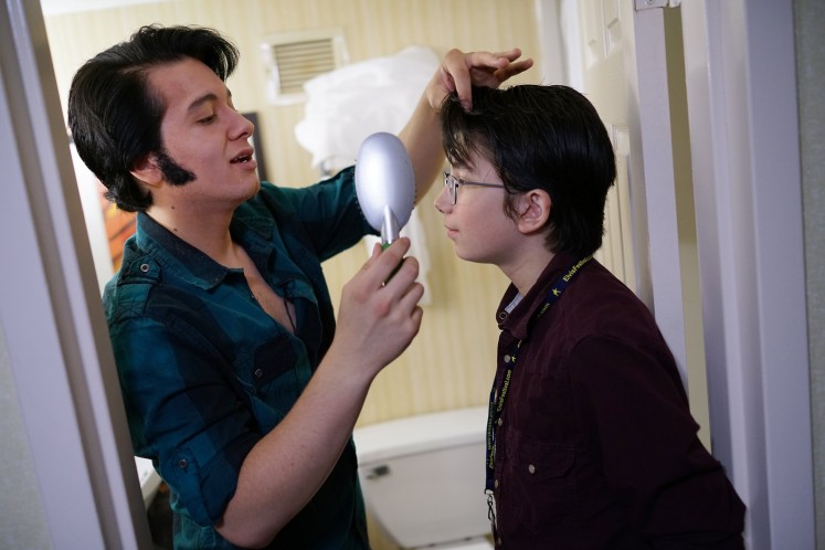Elvis tribute artist Matthew Boyce (L) helps his brother Spencer with his hair while preparing for the 'Images of the King' contest.