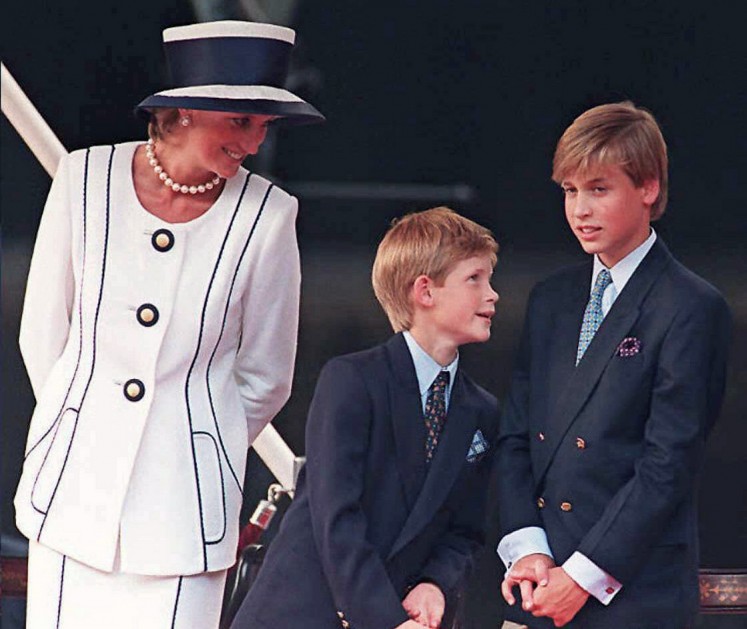 This file photo taken on August 19, 1995 shows Britain's Diana, Princess of Wales (L), and her sons Prince Harry, (C) and Prince William, as they gather for the commemorations of VJ Day in London. 