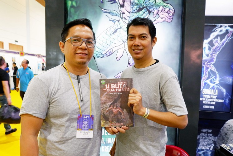 Recreated: Comic writers Iwan Nazif and Oyasujiwo hold the remake of comic book Si Buta dari Goa Hantu.