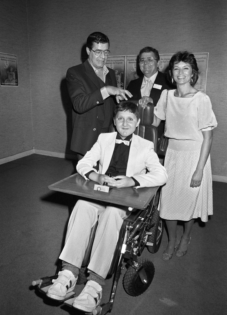 This file photo taken on May 17, 1984 shows
US comedian Jerry Lewis (L), just named Honorable President of French Muscular Dystrophy Association (AMF), accompanied by French actress Christine Delaroche (R) in Paris. Lewis, whose goofy brand of physical comedy endeared him to millions in a career spanning six decades, died on August 20, 2017, aged 91, his agent told AFP. Lewis perfected the role of the quirky clown in slapstick comedies like 