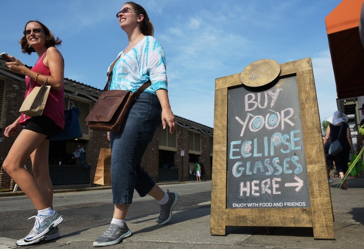 A board advertises eclipse glasses for sale at a restaurant ahead of the total solar eclipse in Charleston, South Carolina, on August 20, 2017. 