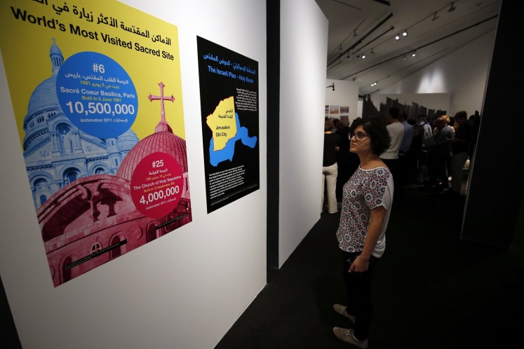 A woman looks at posters during a media tour ahead of the 'Jerusalem Lives' exhibition.
