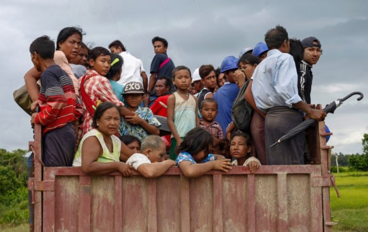 This picture taken on August 25, 2017 shows ethnic Rakhine people fleeing from a conflict area at the Yathae Taung township in Rakhine State in Myanmar. The impoverished western state of Rakhine neighbouring Bangladesh has become a crucible of religious hatred focused on the stateless Rohingya Muslim minority, who are reviled and perceived as illegal immigrants in Buddhist-majority Myanmar.