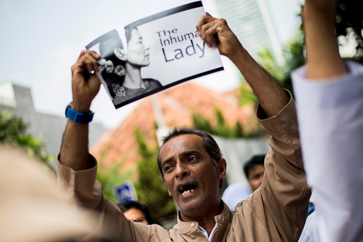 Humanitarian crisis: A protester tears up a picture of Myanmar’s Aung San Suu Kyi during a rally in front of Myanmar Embassy in Jakarta on Saturday to protest the actions of Myanmar’s army and the government of Aung San Suu Kyi. United Nations chief Antonio Guterres warned on Sept. 1 of a looming humanitarian catastrophe in western Myanmar and urged security forces to show restraint after hundreds were reported to have been killed in communal violence.