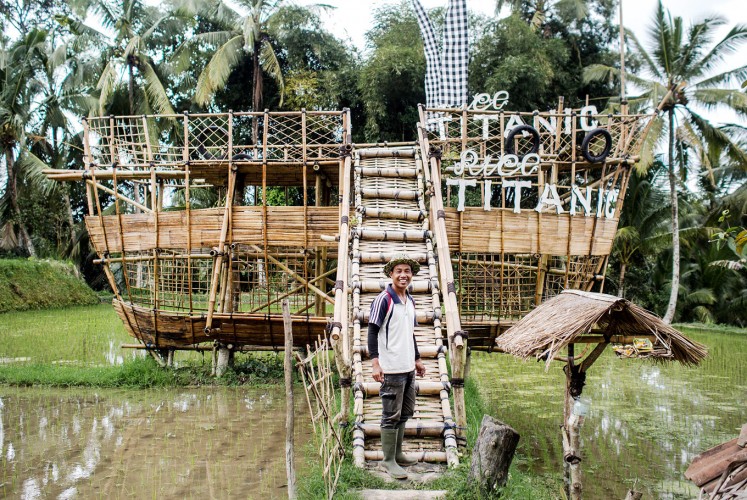 Ride the ship: Nyoman Wastu creates his own tourist attraction from bamboo. His paddy field is located far from the main street, so he has to make an effort to attract tourists.