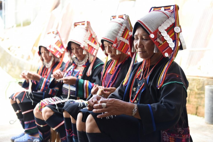 The village elders prepare a homecoming ritual for visitors. 