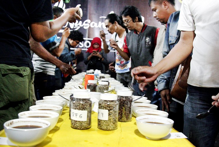 Take a sip: Visitors participate in a coffee-tasting event featuring the produce of coffee farmer groups from 132 regions across the archipelago.