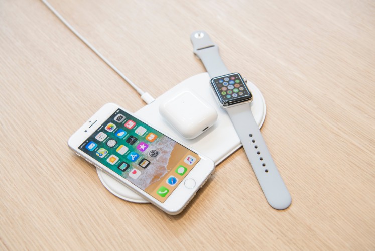 The Apple iPhone 8, Airpods, and Apple Watch on the AirPower charger.