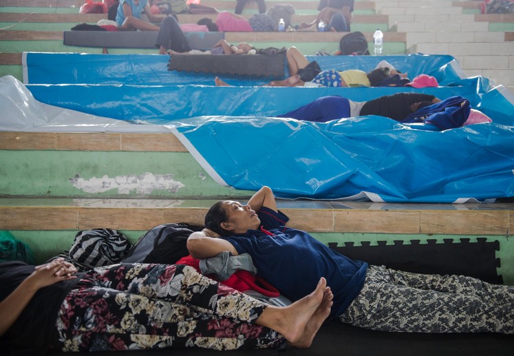 Refugees rest at the Swecapura sports hall in Klungkung, Bali, on Saturday, Sept. 23, 2017. Residents living within a 12-kilometer radius of Mount Agung were told to evacuate in anticipation of an eruption. Local authorities announced the highest possible alert level of the active volcano following an increase in its volcanic activities.