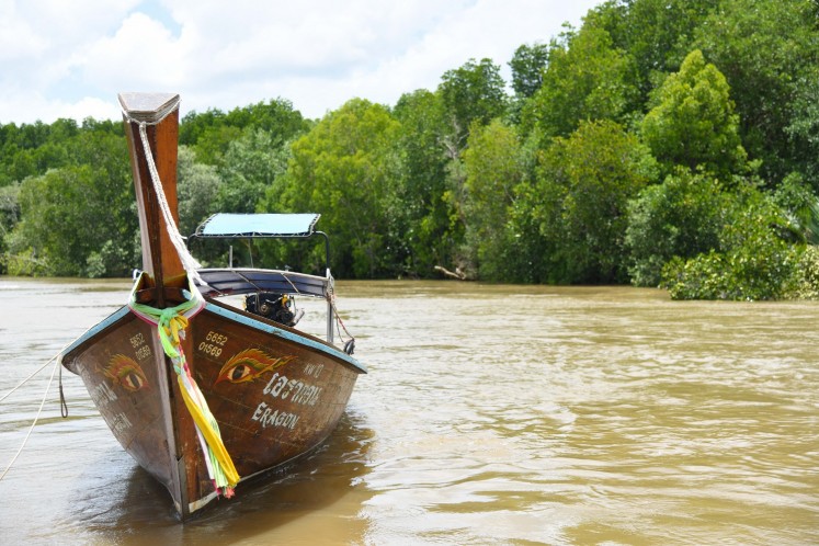 To reach Koh Klang, tourists need to ride a 'hua tong' (traditional long-tail boat).