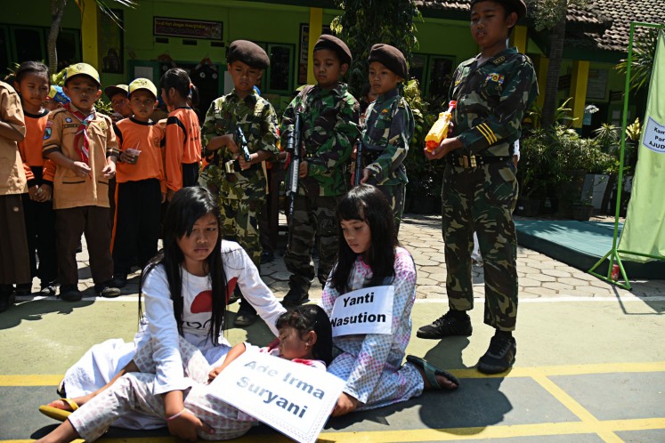 Fun learning: Students of elementary school SD 1 Dinoyo in Malang, East Java, on Friday act in a drama resembling the death of Ade Irma Suryani Nasution during the 1965 communist coup attempt. 