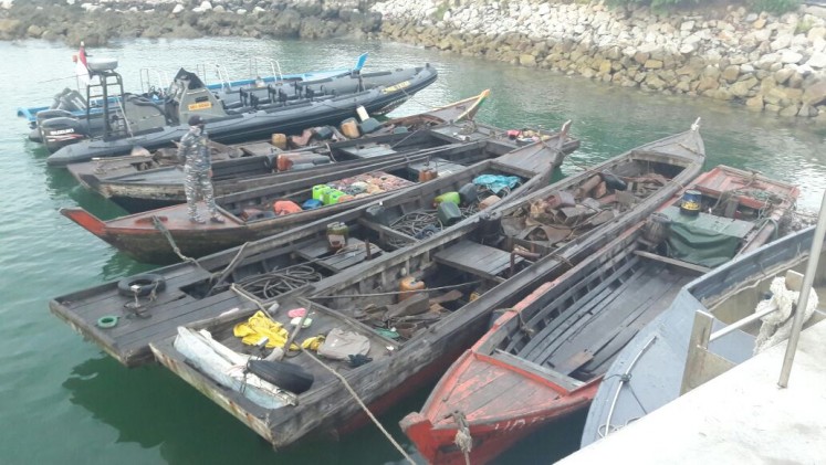 The wooden boats allegedly used by the pirate suspects who were arrested by the Indonesian Navy's Western Fleet Quick Response Unit (WFQR) in Singapore straits on Sunday.