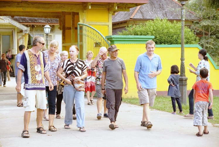 Along the way: Raymond walks with participants in the yacht rally in Sambas Palace in West Kalimantan.