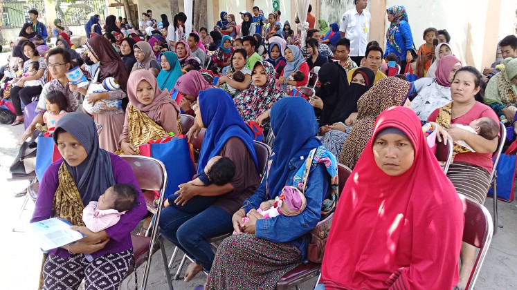 Protecting health: Mothers bring their children to receive pneumococcal conjugate vaccines at Gunungsari Community Health Center in West Lombok, West Nusa Tenggara, on Oct.3.