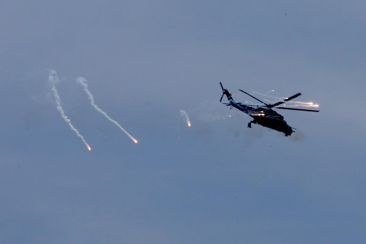 An Mi-35P attack helicopter performs a drill during the commemoration of the 72nd anniversary of the Indonesian Military (TNI) in Cilegon, Banten, on Oct. 5.