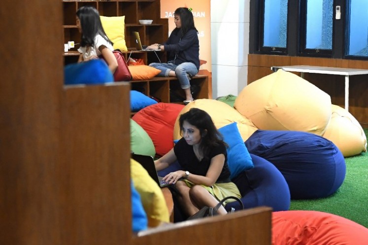 This picture taken on Sept. 12, 2017 shows entrepreneurs working at the EV-Hive event space, a co-working space, in Jakarta. Big-name investors including Expedia and Alibaba are pumping billions of dollars into Indonesian tech start-ups in a bid to capitalise on the country’s burgeoning digital economy and potential as Southeast Asia’s largest online market. Indonesia has seen a surge of cash into its technology sector over the past two years, helping support dozens of homegrown start-ups ranging from ride hailing apps to e-commerce firms.