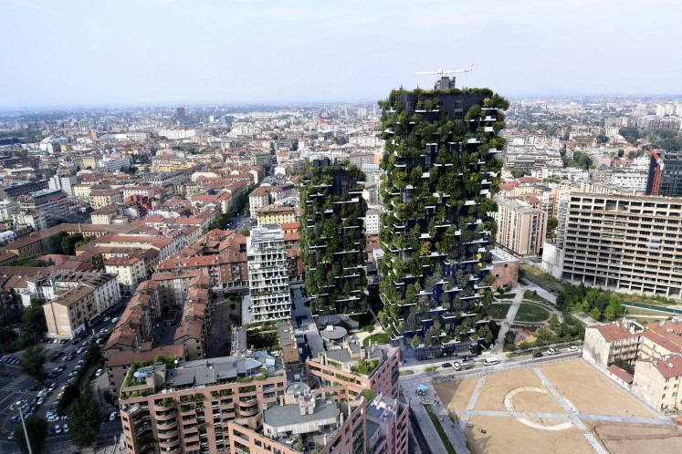 The two original leafy towers dominate the skyline in the northern Italian city, giving residents -- including celebrities like footballer Ivan Perisic -- an enviable view over the new district of Porta Nuova and beyond.
