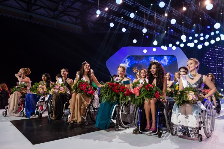 Miss Belarus Aleksandra Chichikova (3rd-R), winner, Second Vice Miss Adriana Zawadzinska of Poland (4th-L), first Vice Miss Lebohang Monyatsi (2nd-R) from South Africa and other participants smile during the final gala of the Miss Wheelchair World contest beauty pageant in Warsaw, on October 7, 2017. 
