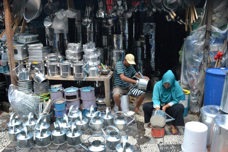 Vendors ready upcycled gas jugs in their stall at Kabangan Market.