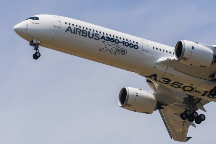 An Airbus A350-1000 XWB jet airliner performs its show flight during the International Paris Air Show at Le Bourget, north of Paris, on June 20, 2017. 