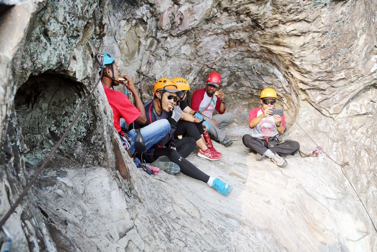 Rest and relax: Ogun and his fellow climbers take a break during a climb.