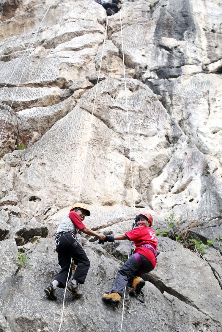 Always together: Ogun and his wife, Cecilia Yashita, hold hands during a climb.