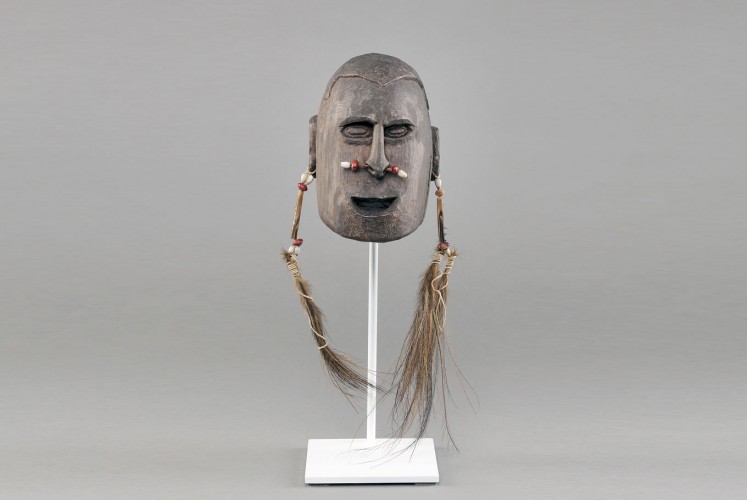 Tribal life: The wooden head statue symbolizes the Asmat people’s old head hunting tradition.