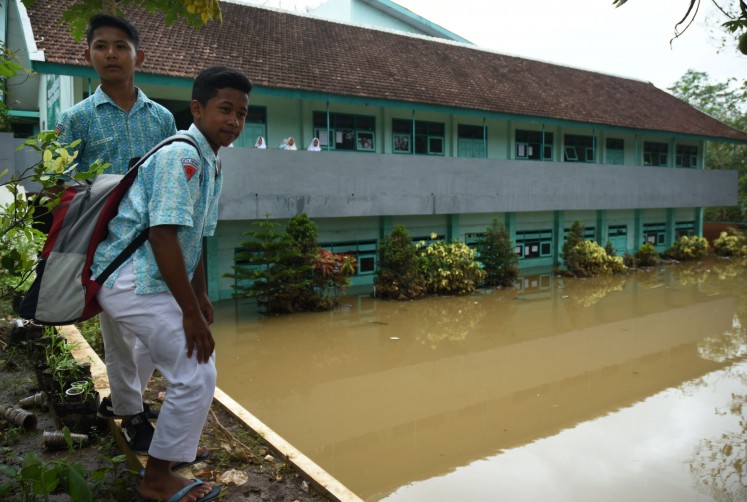 The Tsanawiyah Hargokuncaran Islamic high school in Malang, East Java, is inundated by four meters of floodwater on Wednesday.