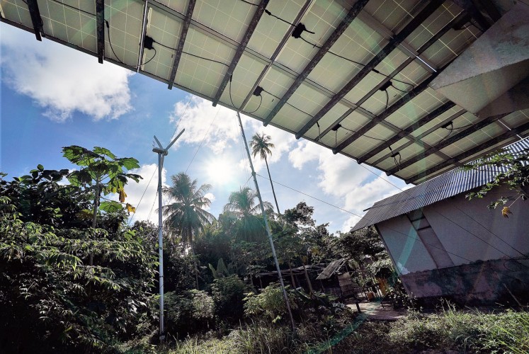Dynamic duo: Residents on Maratua use the combination of solar energy and a windmill to generate electricity.